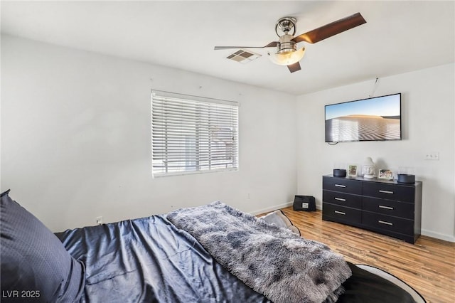 bedroom with hardwood / wood-style floors and ceiling fan