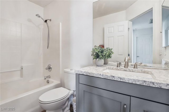 full bathroom with toilet, vanity, and washtub / shower combination