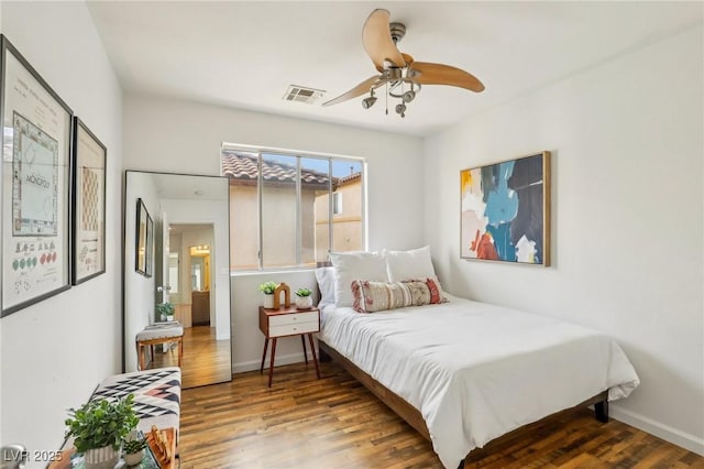 bedroom with ceiling fan and wood-type flooring