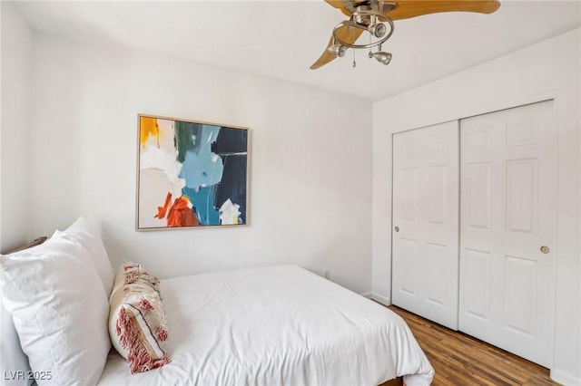 bedroom with a closet, ceiling fan, and dark wood-type flooring