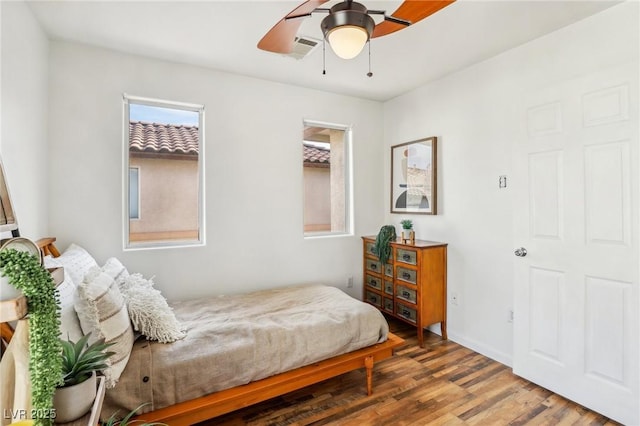 bedroom featuring hardwood / wood-style flooring and ceiling fan