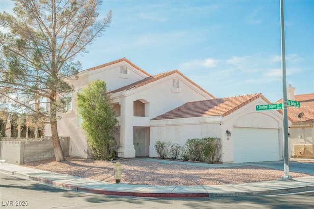 mediterranean / spanish-style house featuring a garage