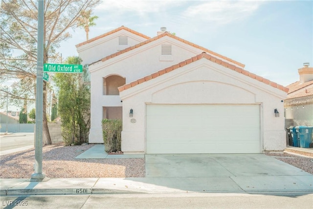 mediterranean / spanish house with a garage