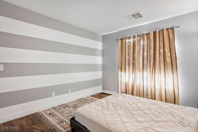 bedroom with hardwood / wood-style flooring