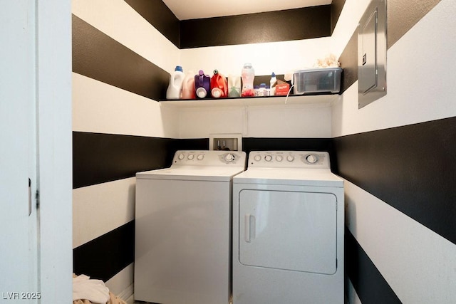 laundry room featuring washer and dryer and electric panel