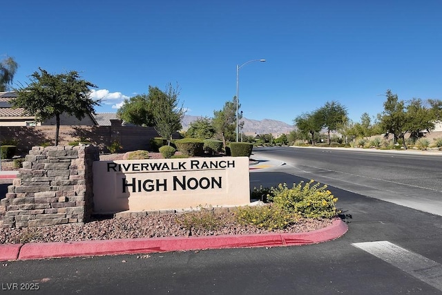 community sign with a mountain view