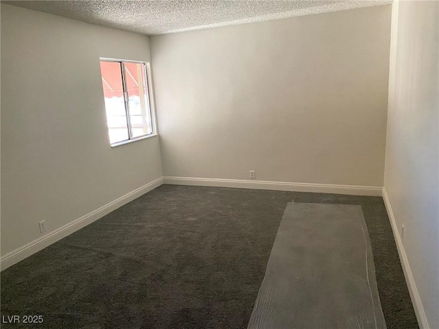 carpeted spare room with a textured ceiling