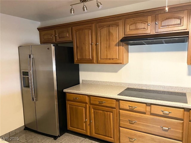 kitchen with stainless steel refrigerator with ice dispenser and black electric stovetop