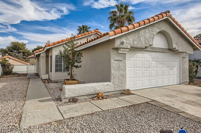 ranch-style home featuring a garage