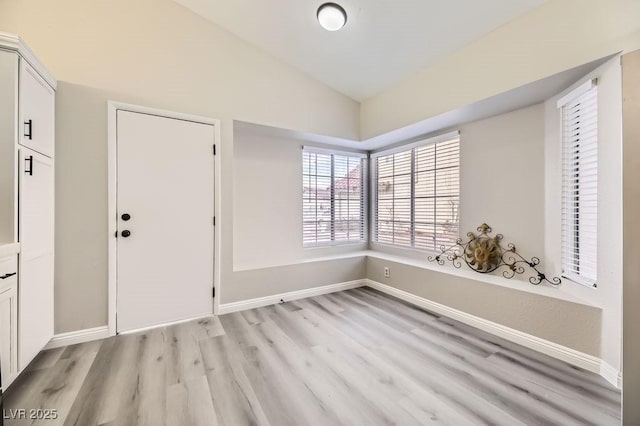 entryway featuring light hardwood / wood-style flooring and vaulted ceiling