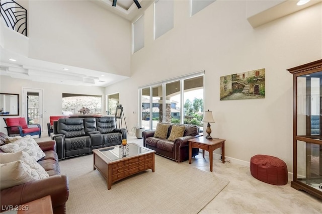 living room with a high ceiling and ceiling fan