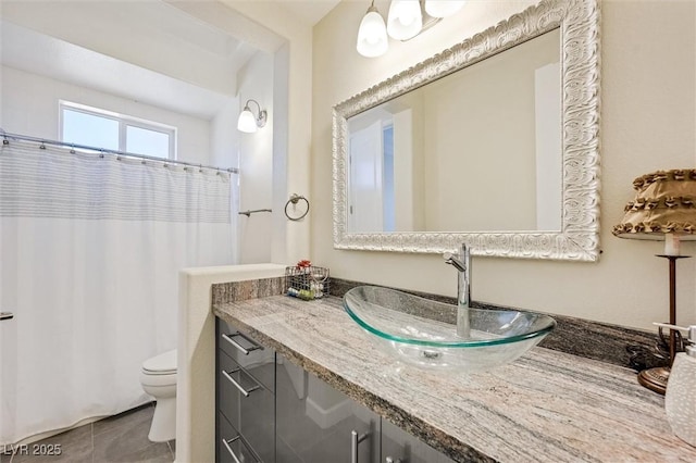 bathroom featuring vanity, toilet, and tile patterned flooring