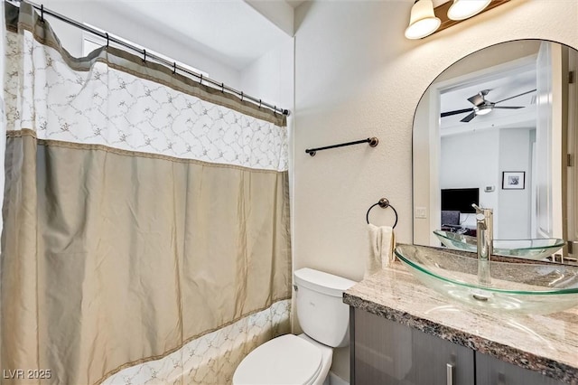 full bathroom featuring ceiling fan, vanity, toilet, and shower / bath combo