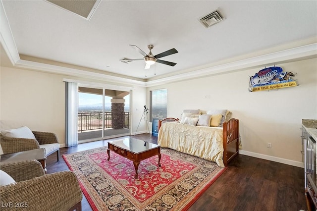 bedroom featuring dark wood-type flooring, ceiling fan, a raised ceiling, and access to outside