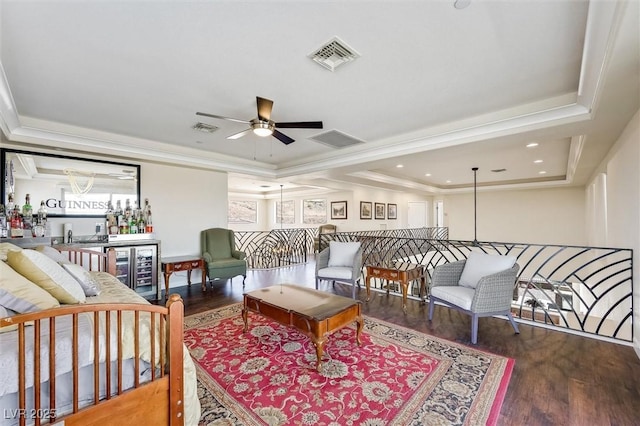 living room with wine cooler, a tray ceiling, ceiling fan, and hardwood / wood-style flooring