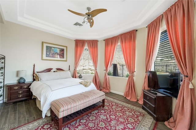 bedroom featuring ceiling fan and a tray ceiling