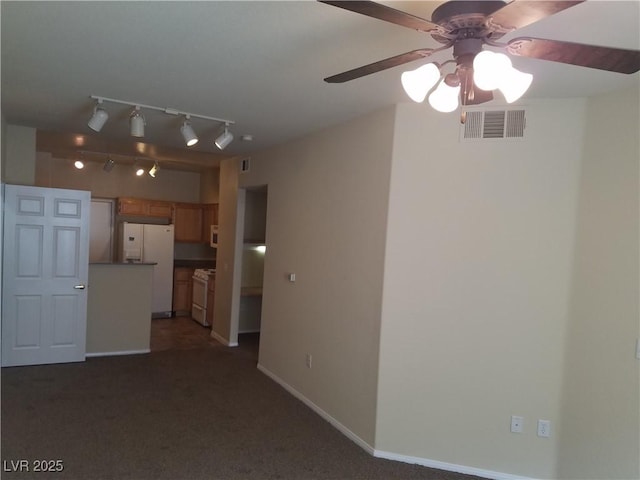 unfurnished living room featuring dark colored carpet and ceiling fan