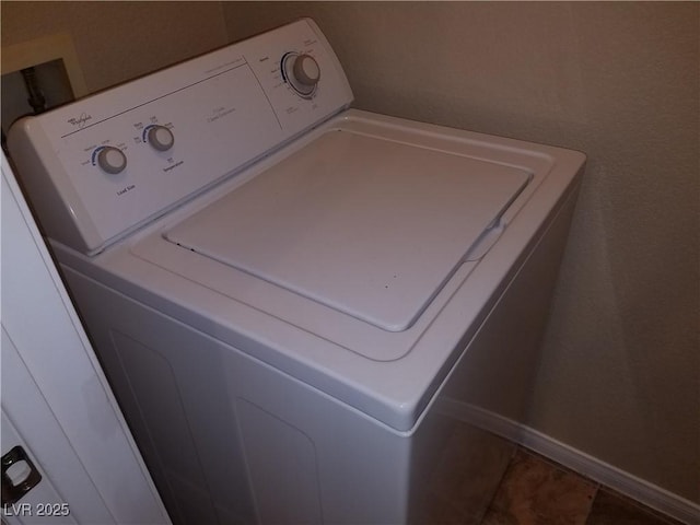 clothes washing area with tile patterned flooring and washer / dryer