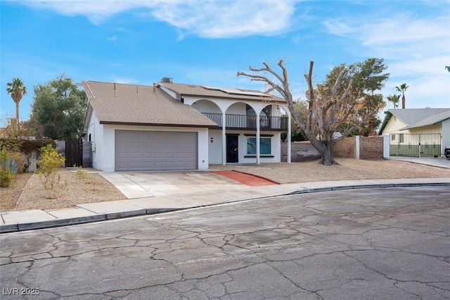 view of front of property with a balcony and a garage