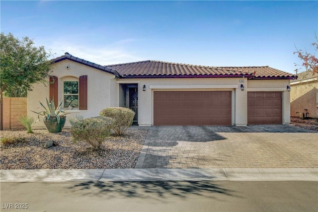 mediterranean / spanish-style home with a garage