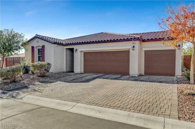 mediterranean / spanish-style house with a garage