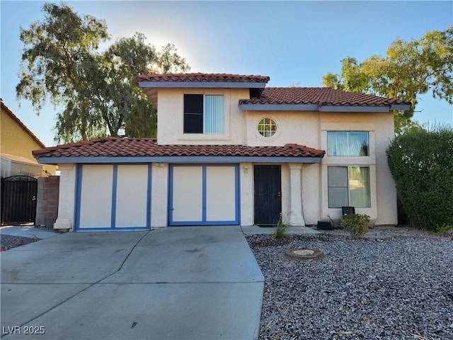 mediterranean / spanish house with a garage