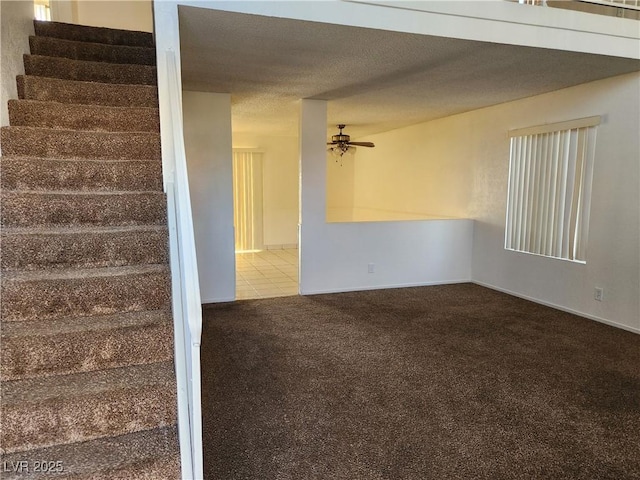 interior space featuring ceiling fan and a textured ceiling