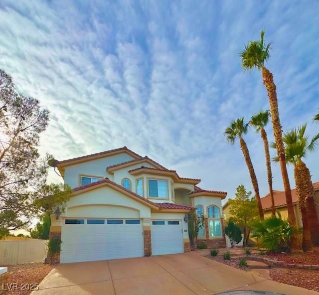 mediterranean / spanish house featuring a garage