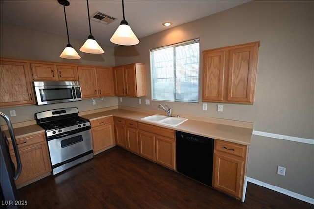 kitchen featuring pendant lighting, dark hardwood / wood-style flooring, sink, and stainless steel appliances