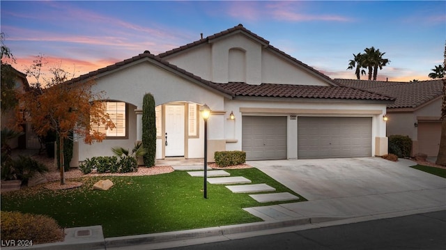 view of front of house featuring a yard and a garage