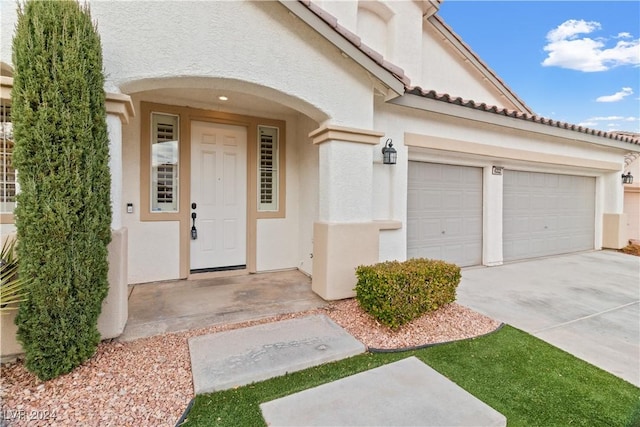 doorway to property with a garage