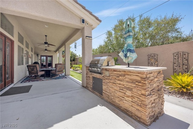 view of patio with a grill, ceiling fan, french doors, and area for grilling