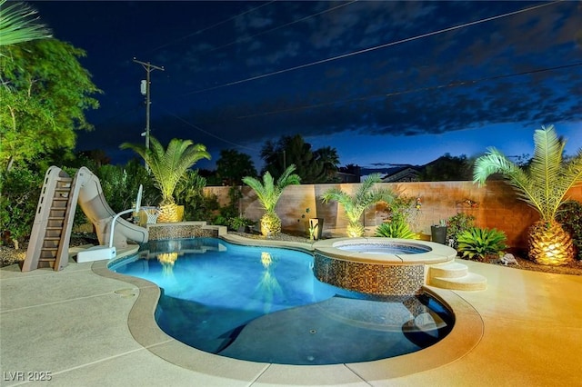 view of pool with an in ground hot tub and a water slide