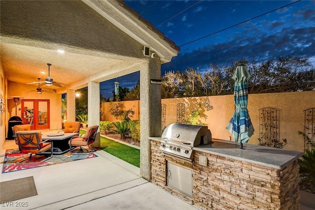 view of patio with area for grilling, grilling area, and ceiling fan