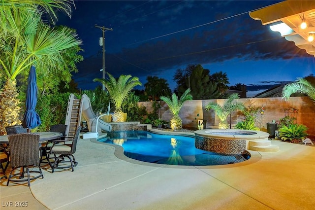 view of pool featuring an in ground hot tub, a patio, and a water slide