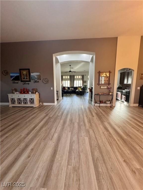 living room with wood-type flooring and ceiling fan