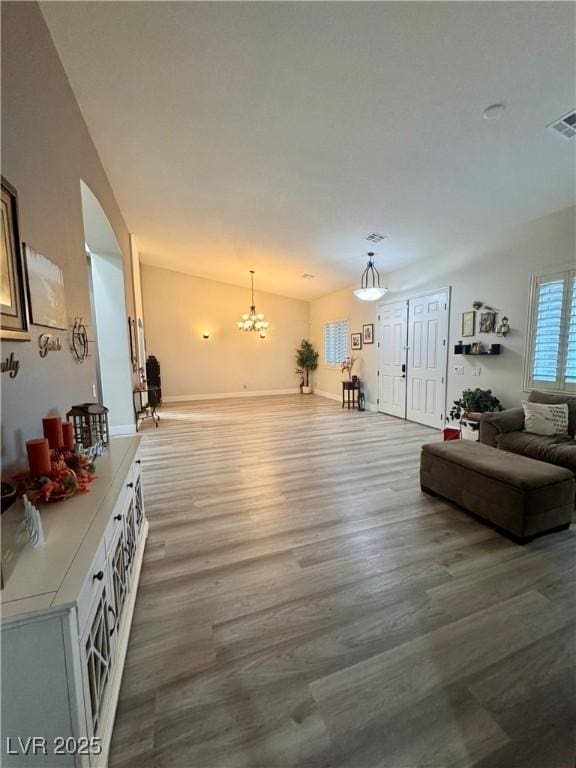 living room with hardwood / wood-style flooring and an inviting chandelier