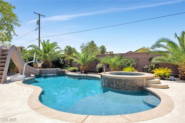 view of pool featuring an in ground hot tub and a water slide