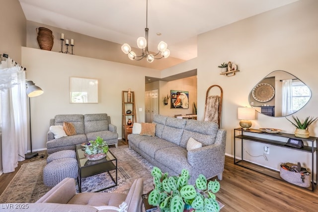 living room with hardwood / wood-style flooring and a notable chandelier