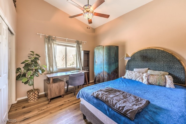 bedroom featuring wood-type flooring, a closet, ceiling fan, and lofted ceiling