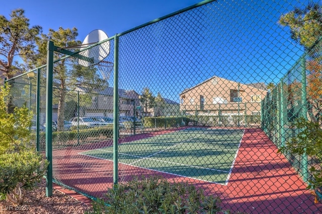 view of tennis court featuring basketball hoop