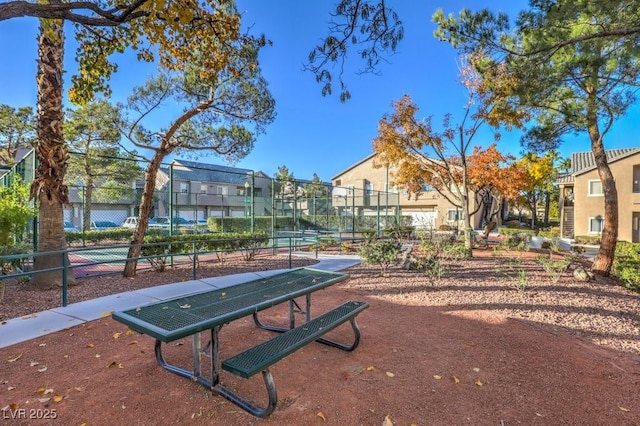 view of home's community with tennis court