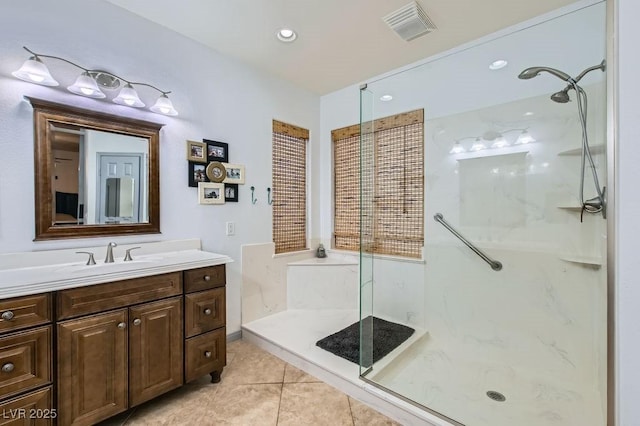 bathroom featuring tile patterned floors, vanity, and walk in shower