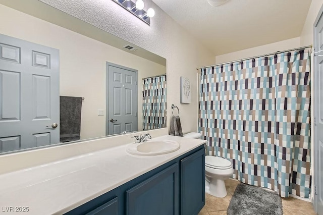 bathroom featuring a textured ceiling, vanity, tile patterned flooring, toilet, and curtained shower