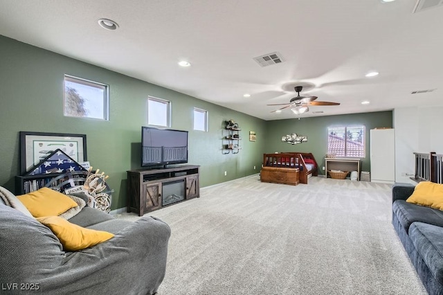 carpeted living room featuring ceiling fan