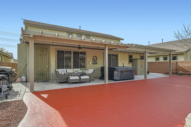 back of house with a patio area, a hot tub, and an outdoor hangout area