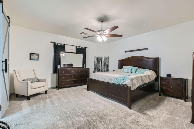 bedroom featuring ceiling fan and light carpet