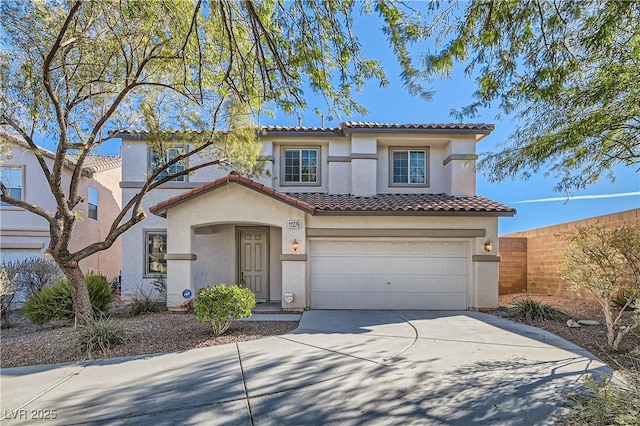 mediterranean / spanish-style home with a tile roof, stucco siding, an attached garage, fence, and driveway