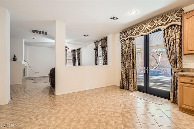 empty room featuring french doors and visible vents