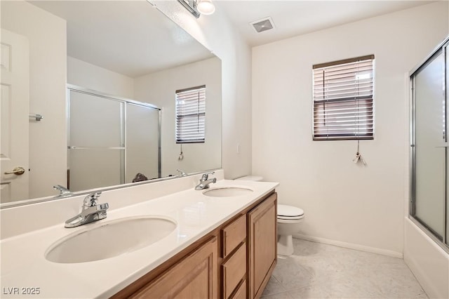 full bath with toilet, a healthy amount of sunlight, visible vents, and a sink